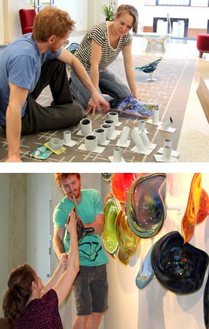 Photo of Rachel Haynes and her husband Josh working on the installation of the glass blown roundels.